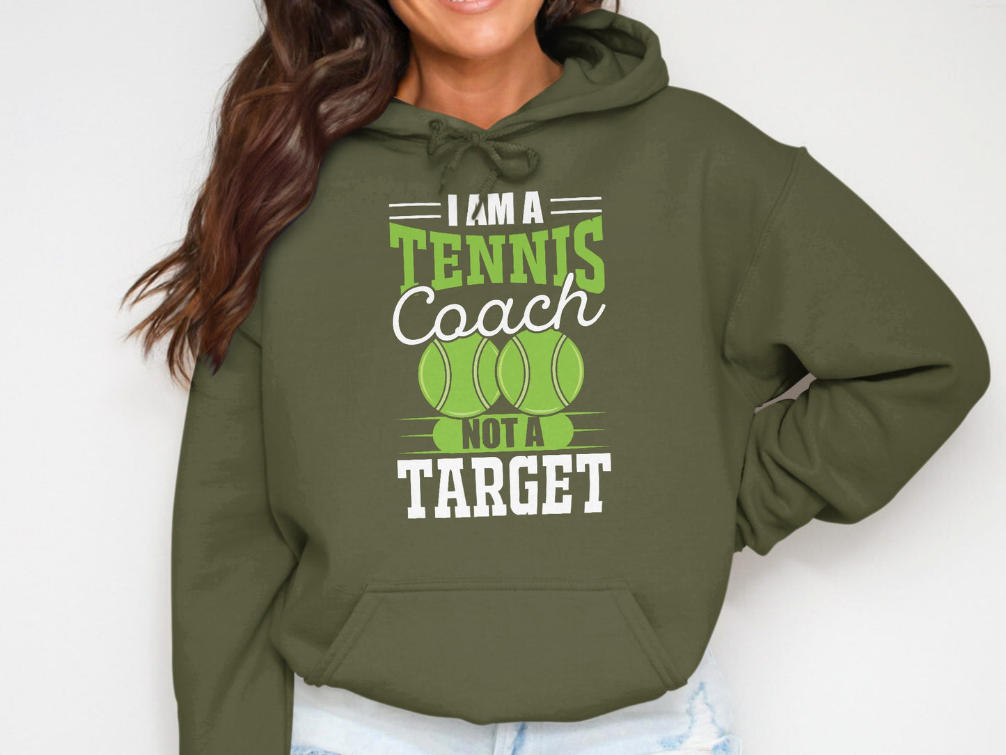 Green hoodie with "I am a tennis coach, not a target" text and tennis balls.