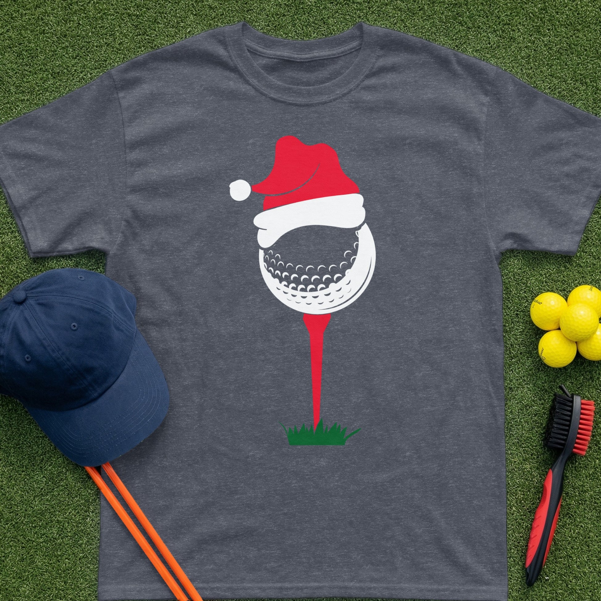 T-shirt with a graphic of a golf ball on a tee wearing a Santa hat.