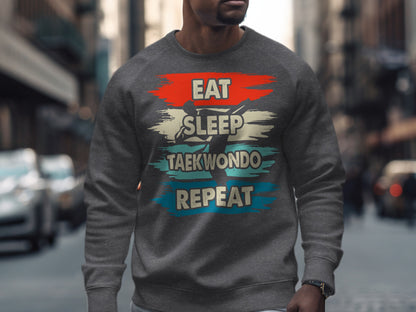 Grey sweatshirt with "Eat Sleep Taekwondo Repeat" text design.