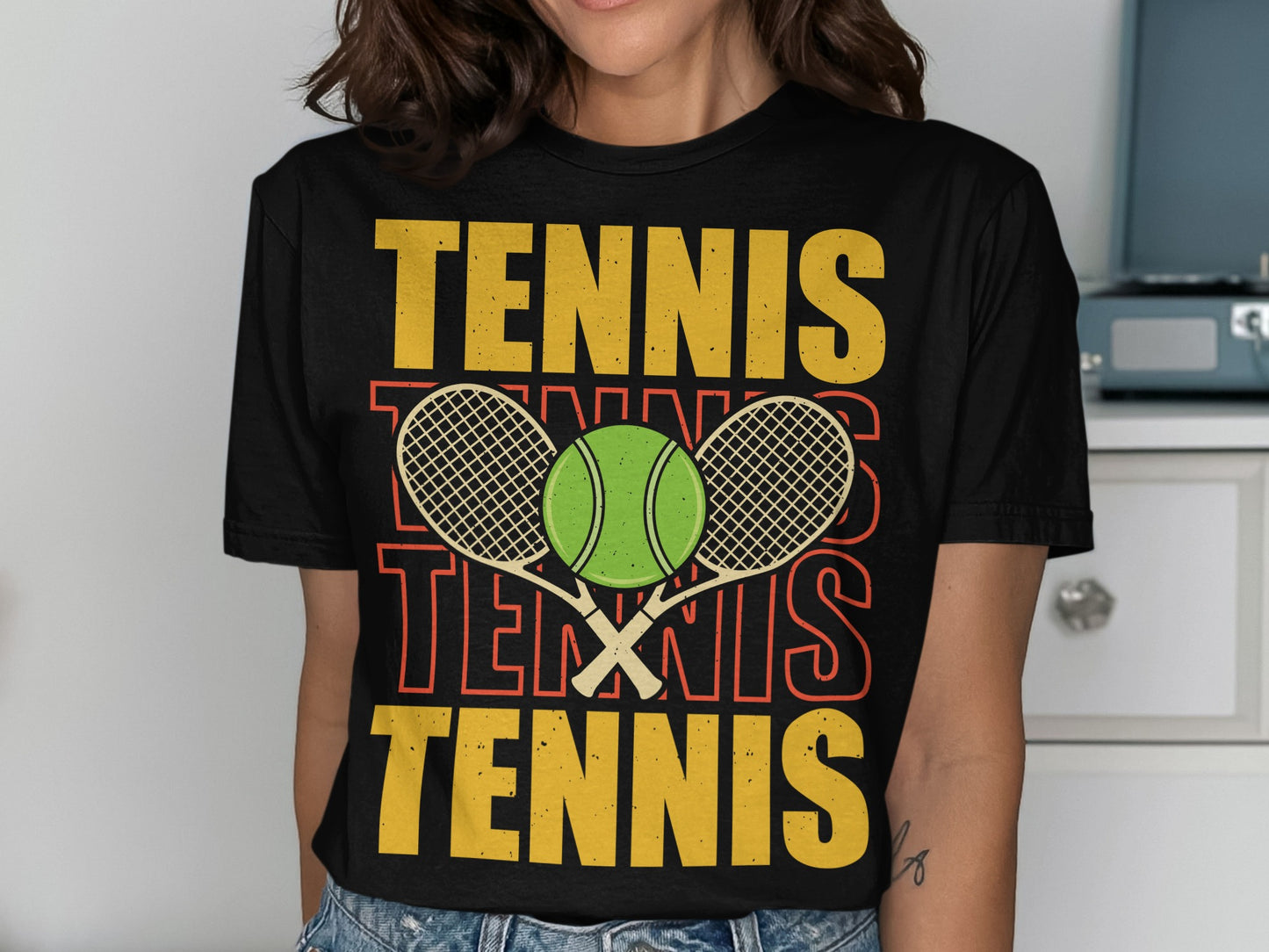 Black t-shirt with "TENNIS" repeated in yellow and orange, and a tennis ball and rackets.