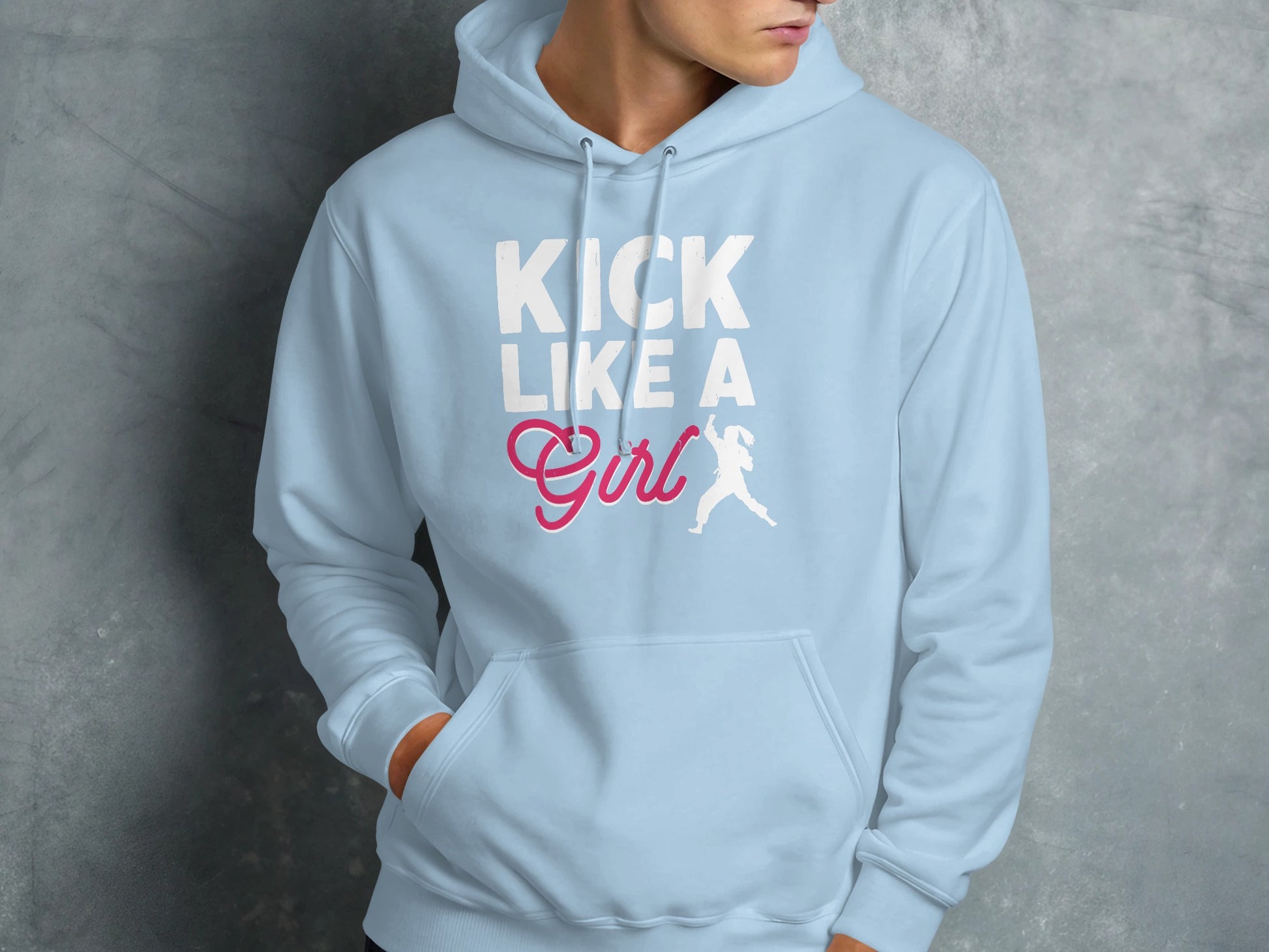 Light blue hoodie with "KICK LIKE A GIRL" in white and pink text with a female runner graphic.