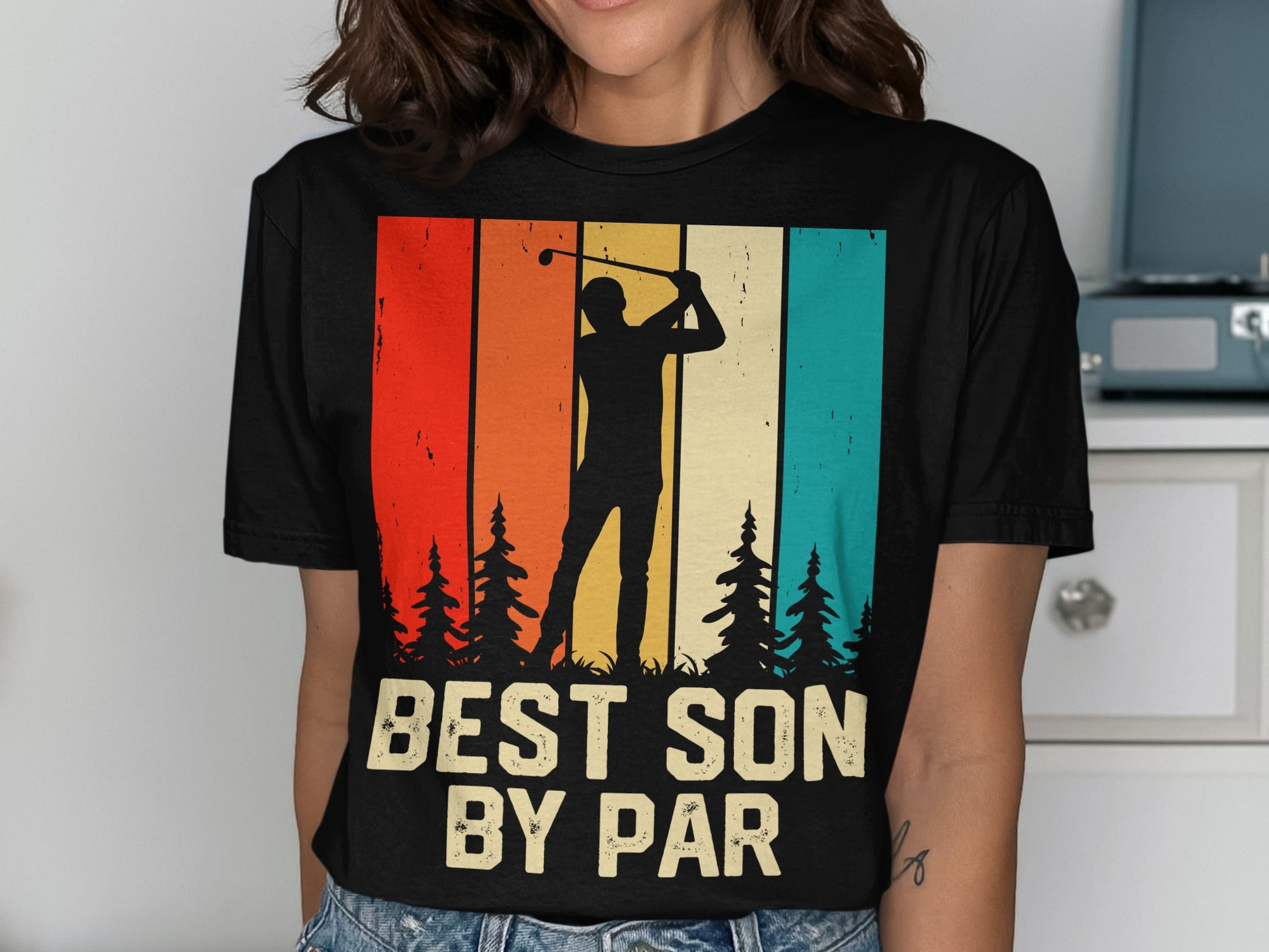 Black t-shirt with golfer silhouette, trees, and text "BEST SON BY PAR".