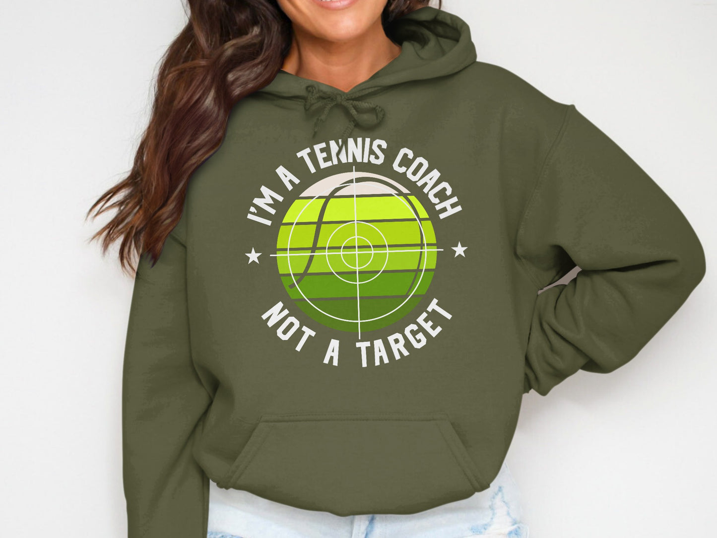 Olive hoodie with "I'm a tennis coach, not a target" graphic.