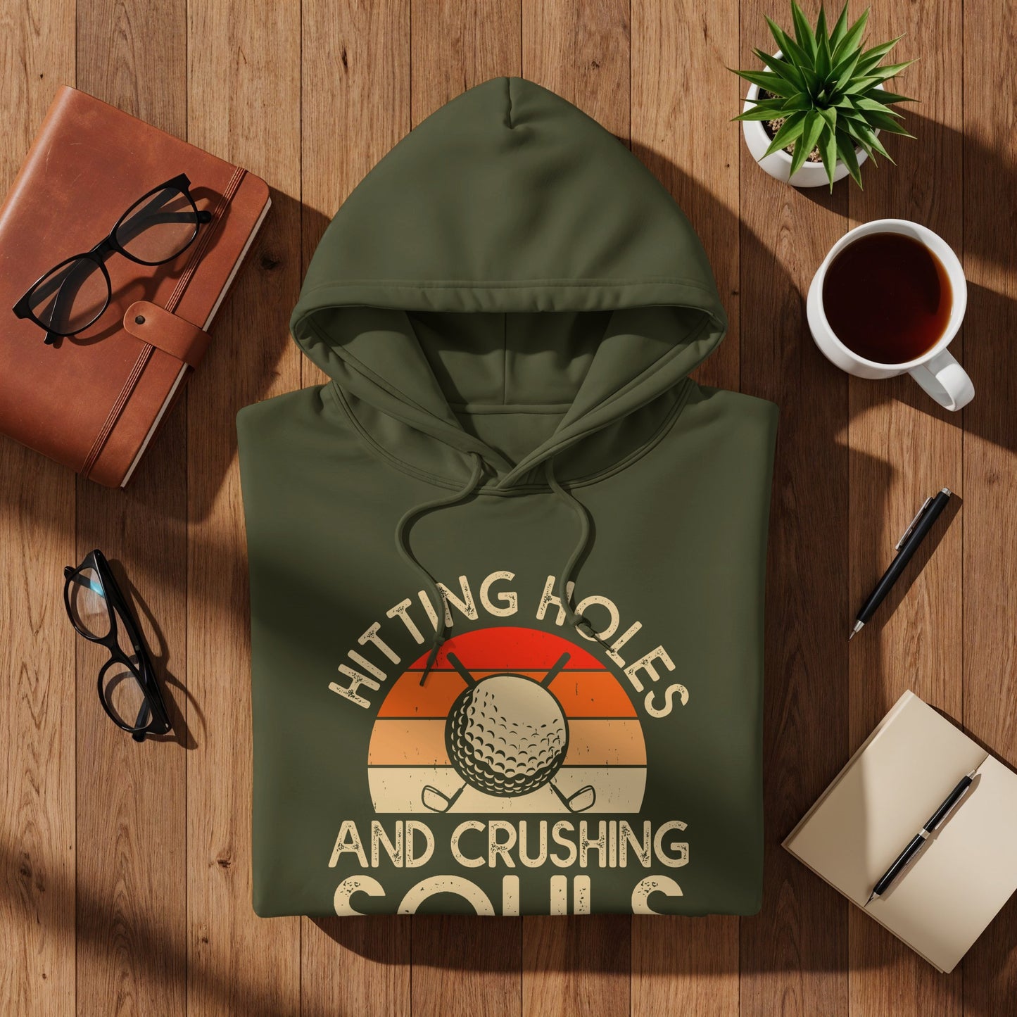 Green hoodie with "Hitting Holes and Crushing Souls" text and golf graphic.