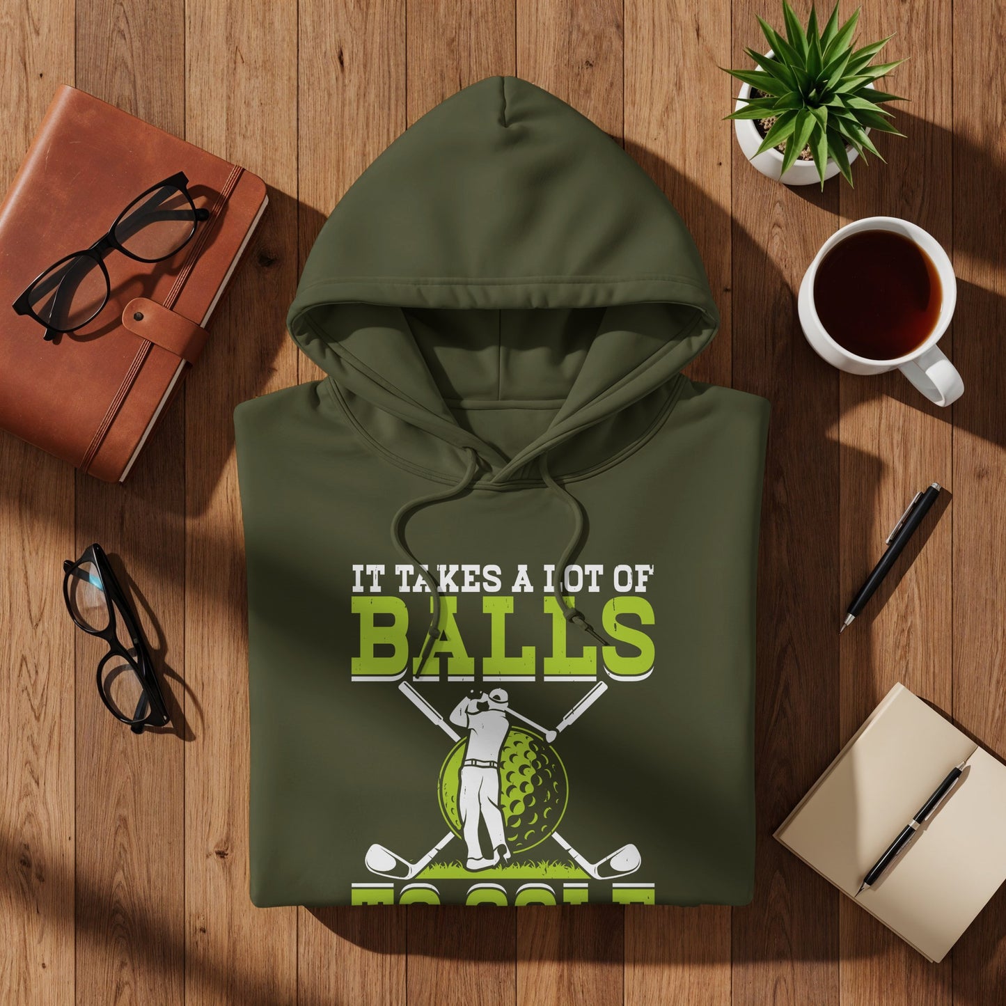 Green hooded sweatshirt with "It Takes a Lot of Balls to Golf" text and golf graphics.