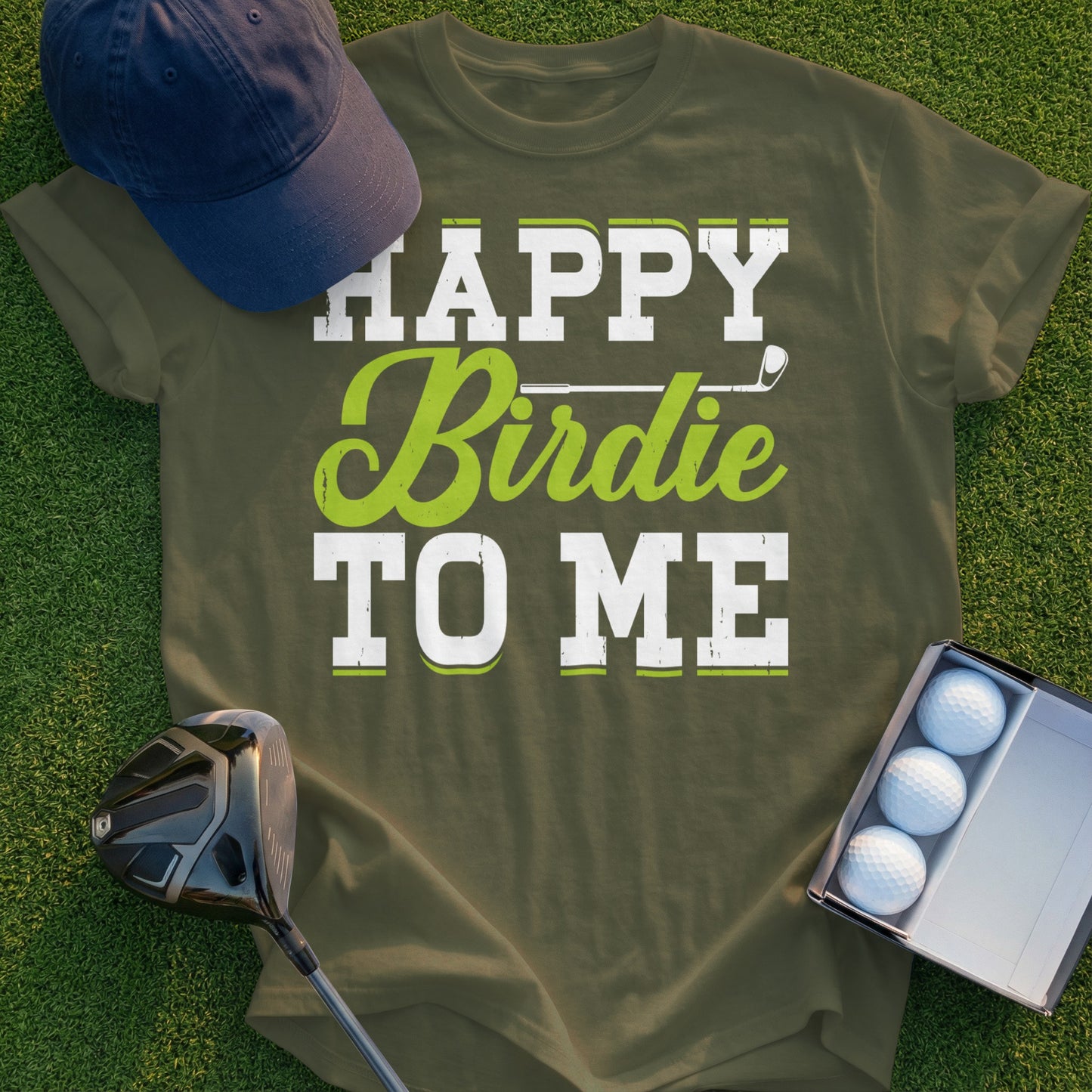 Green t-shirt with "Happy Birdie TO ME" text and golf club and balls.
