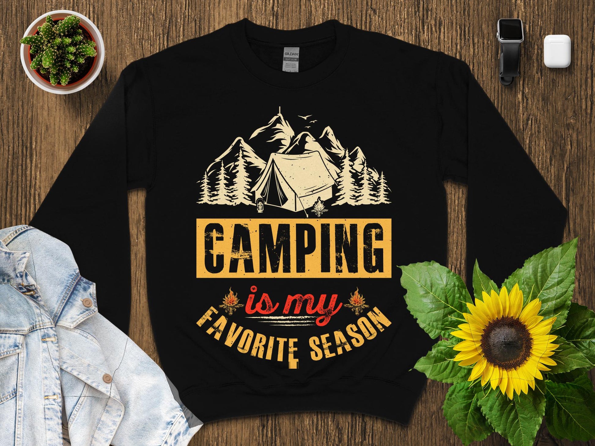 Black sweatshirt with "Camping is my favorite season" text and mountain graphic.
