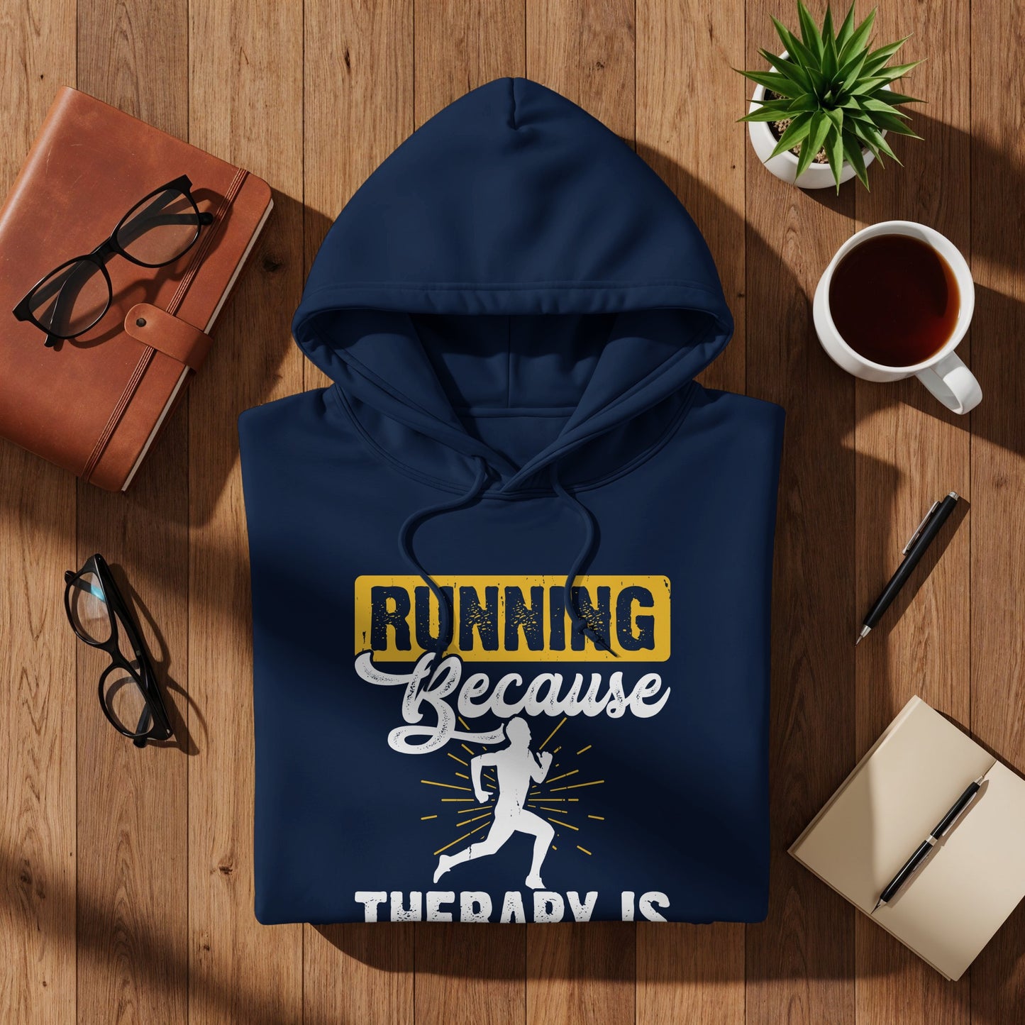 Navy hoodie with "Running Because Therapy Is" graphic and running silhouette.