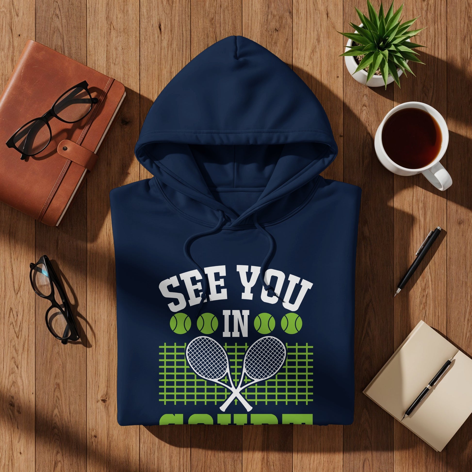 Navy hoodie with "See You In" text, tennis rackets, and green net graphic.