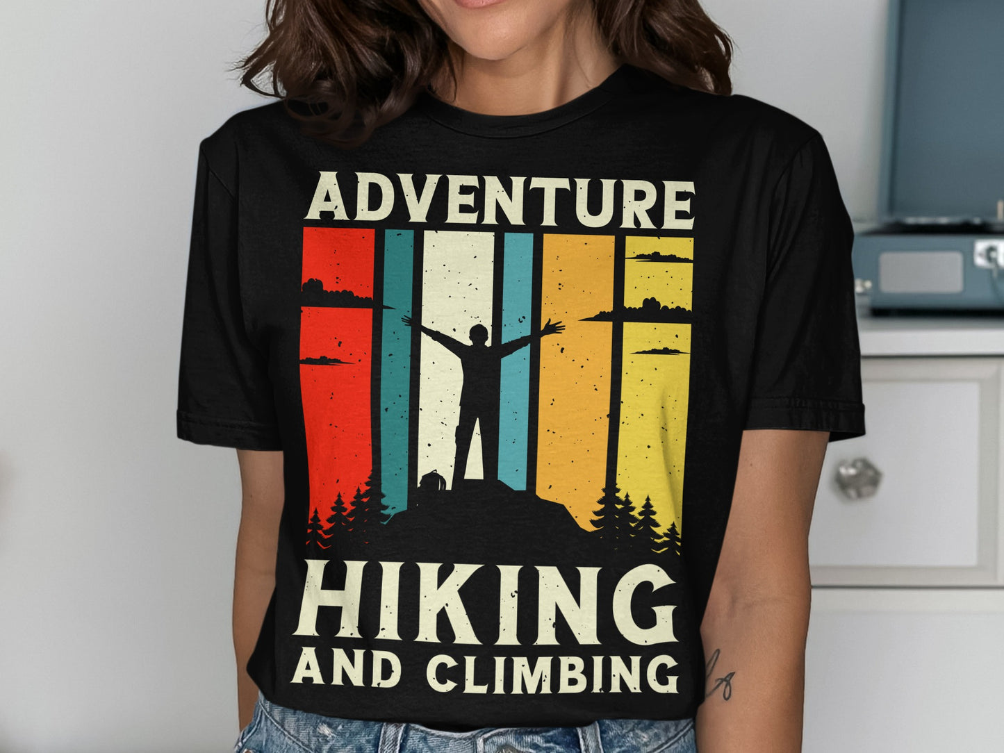 T-shirt with silhouette of hiker on mountain, text "HIKING AND CLIMBING".