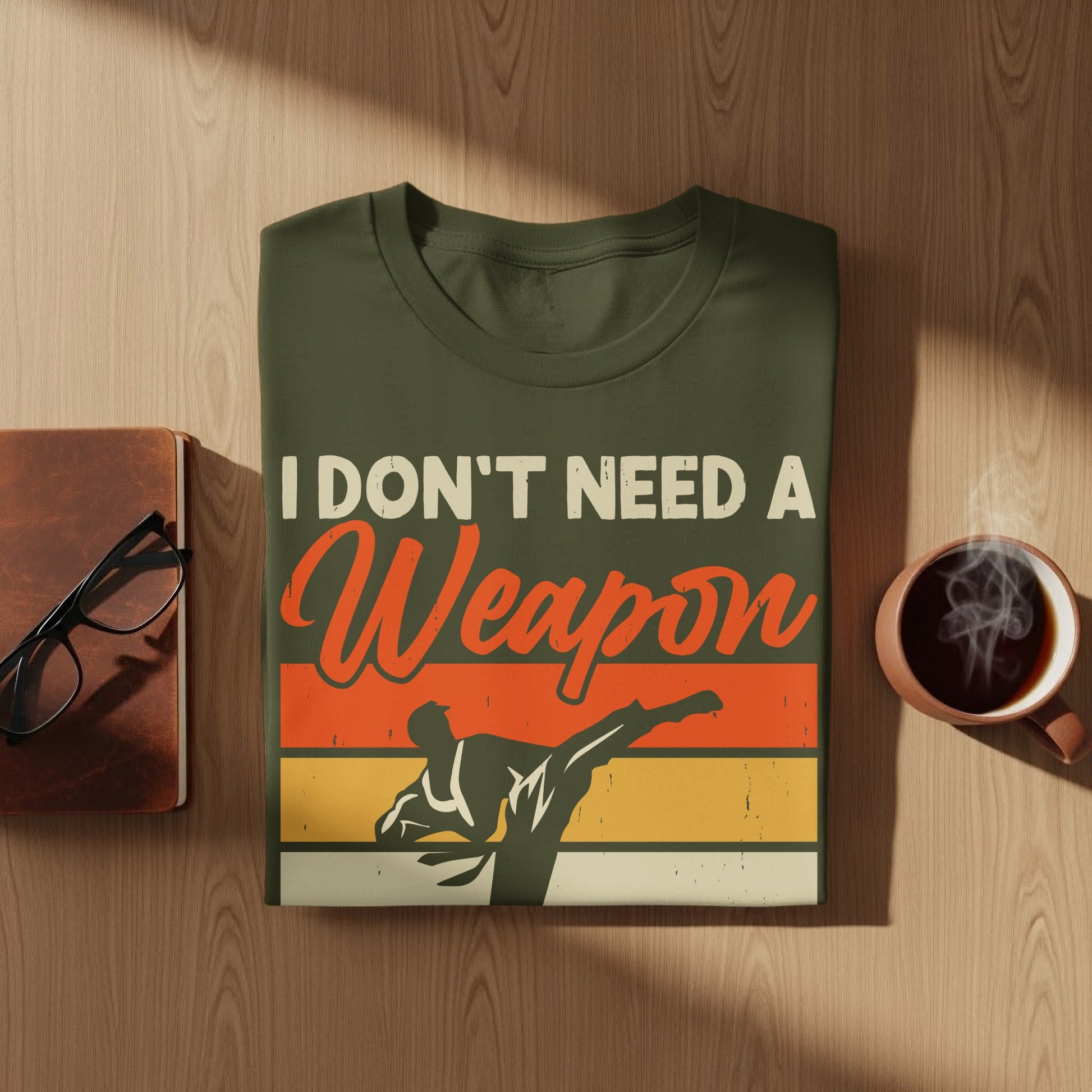 Olive green t-shirt with "I don't need a weapon" and martial artist graphic.