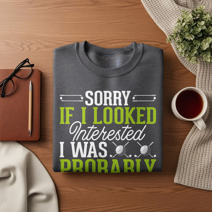 Grey sweatshirt with "Sorry if I looked interested I was probably" text and golf graphic.