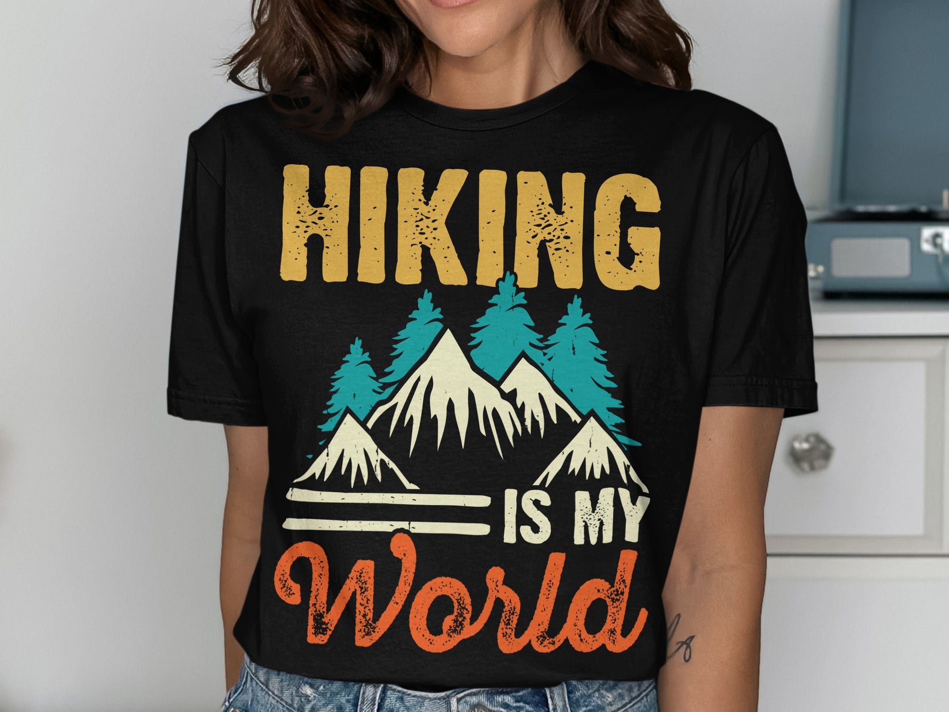 Black t-shirt with "Hiking is my world" text and mountain graphic.