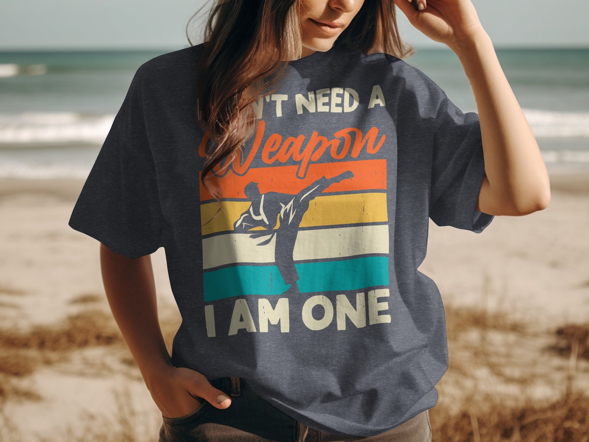 Dark t-shirt with retro graphic of a martial artist and text "DON'T NEED A WEAPON I AM ONE".