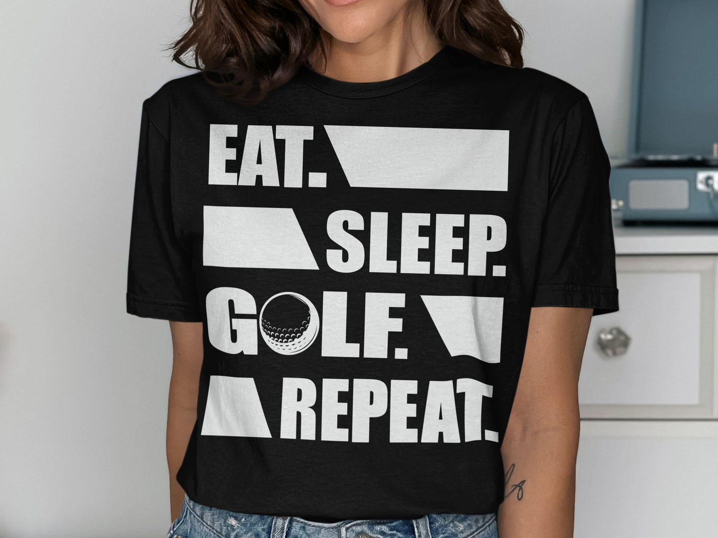 Black t-shirt with "EAT. SLEEP. GOLF. REPEAT." text and golf ball.