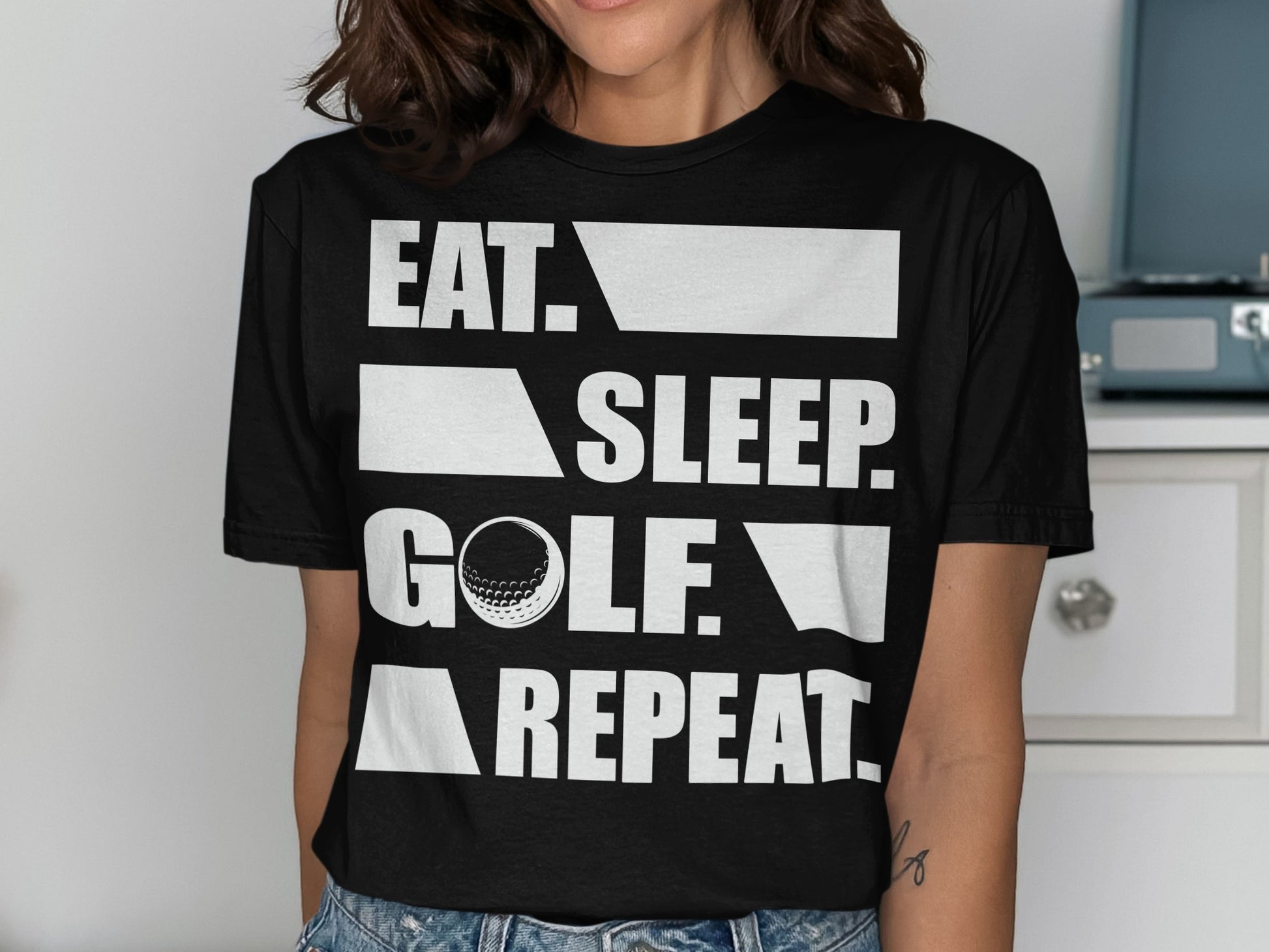 Black t-shirt with "EAT. SLEEP. GOLF. REPEAT." text and golf ball.