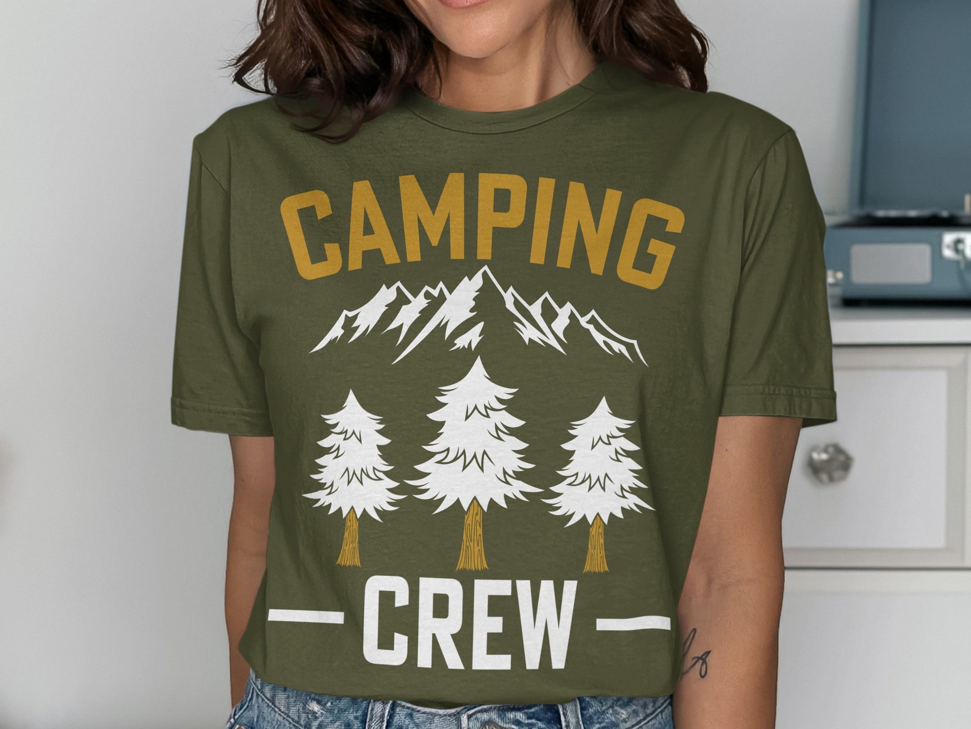 Green t-shirt with "CAMPING CREW" text, mountains, and trees design.