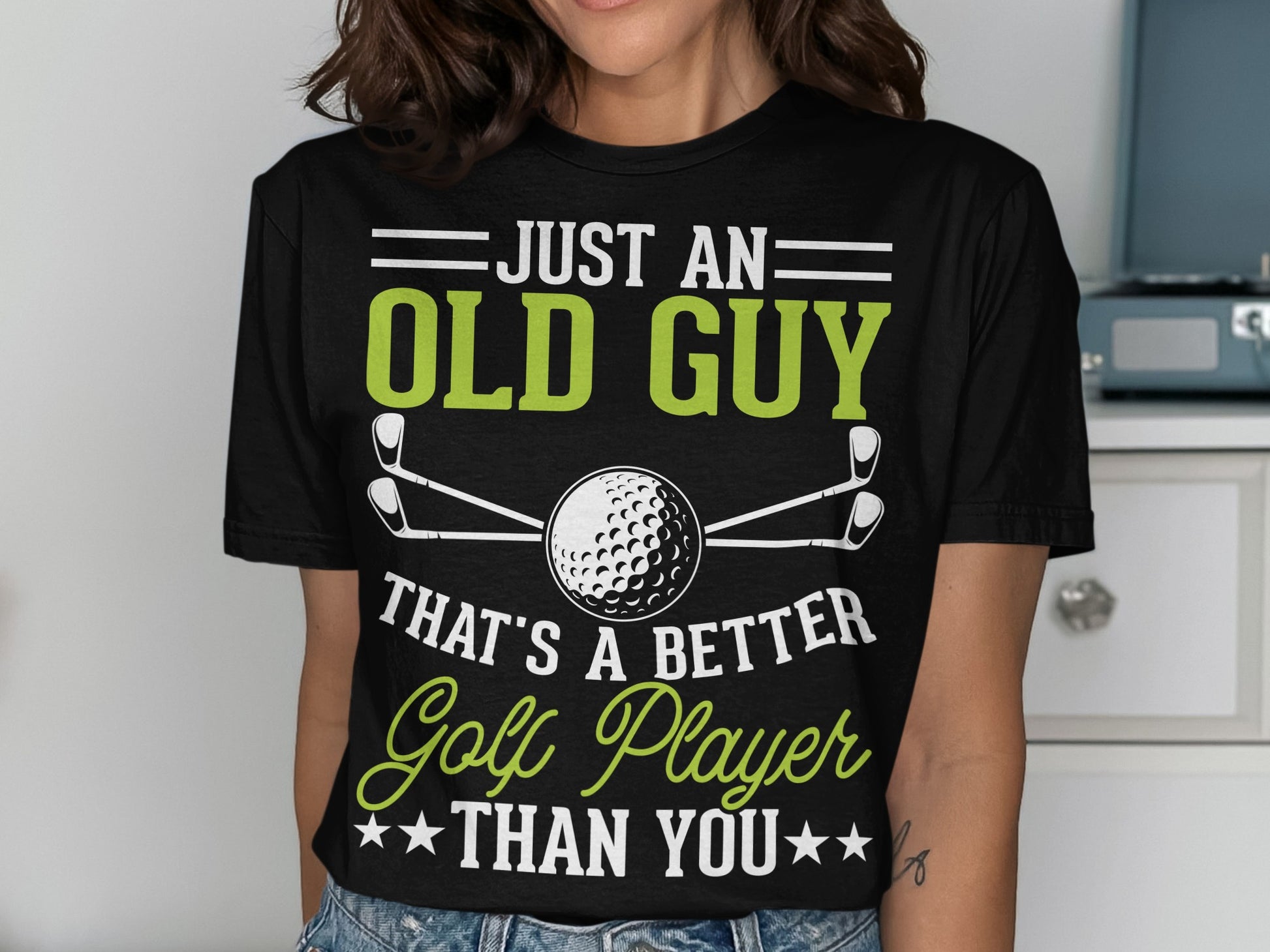 Black t-shirt with green text reading "Just an old guy that's a better golf player than you".