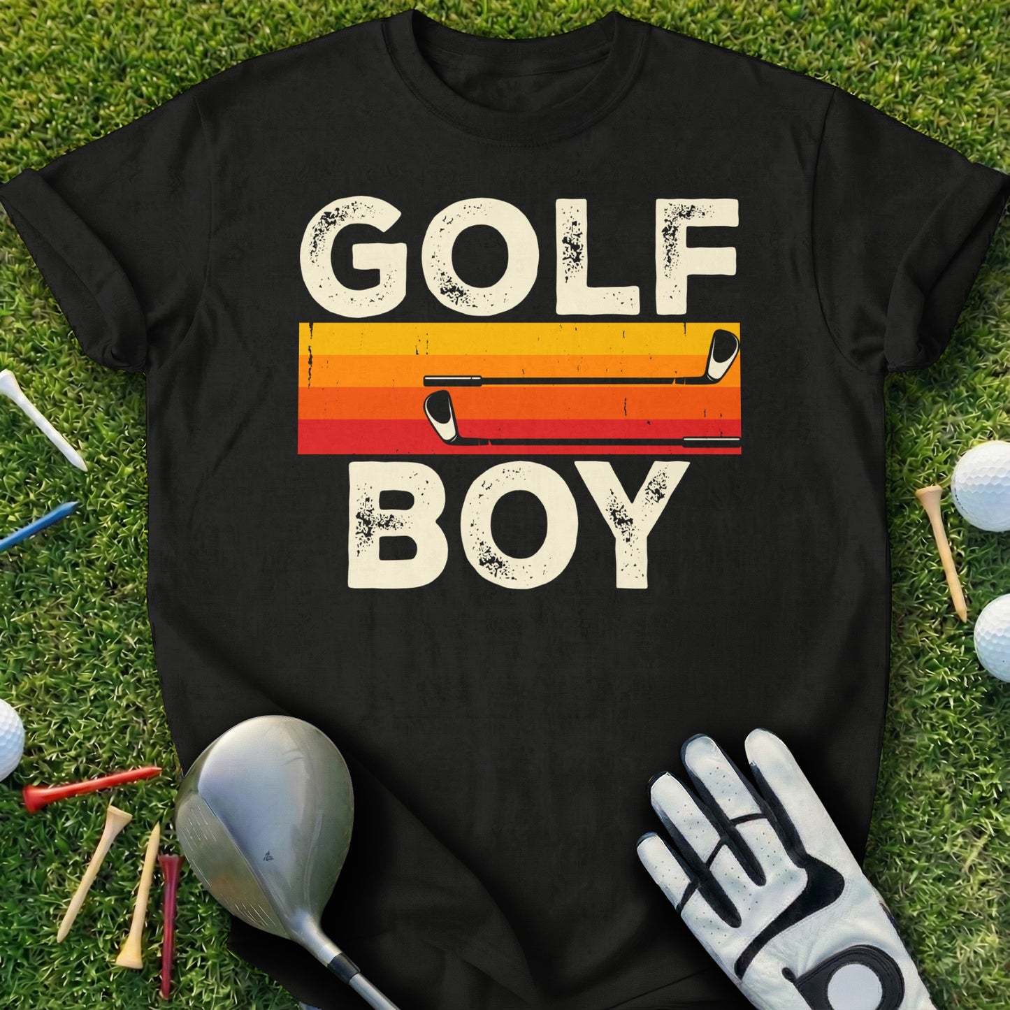 Black t-shirt with "GOLF BOY" in large letters and golf clubs on grass.