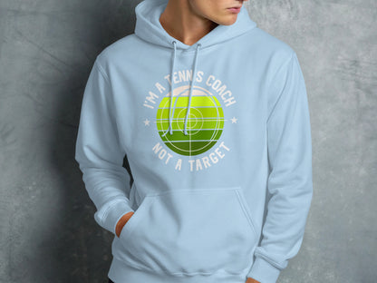 Light blue hoodie with "I'm a tennis coach, not a target" graphic.
