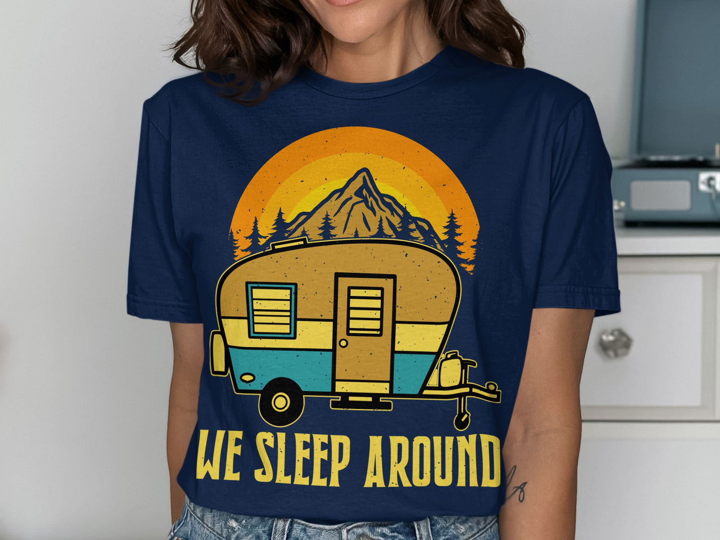 T-shirt with a camper, mountain, and "WE SLEEP AROUND" text.