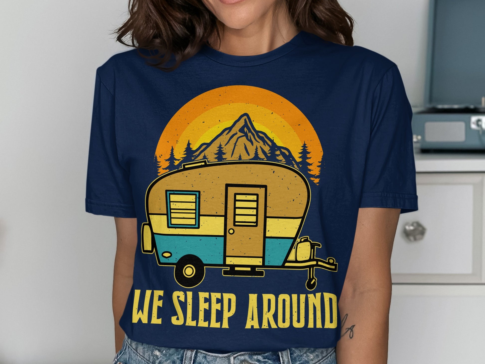 T-shirt with a camper, mountain, and "WE SLEEP AROUND" text.