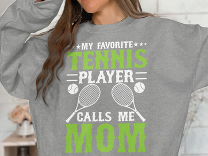 Grey sweatshirt with "My Favorite Tennis Player Calls Me Mom" and tennis graphics.