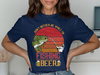Dark blue t-shirt with "Don't Bother Me While I'm Fishing Unless You Brought Beer" slogan and fishing graphic.