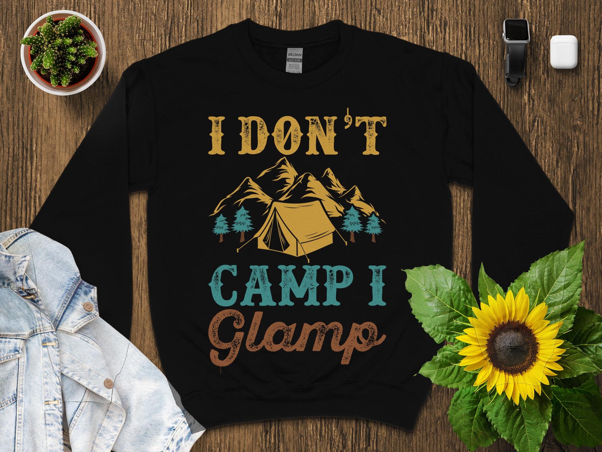 Black sweatshirt with "I Don't Camp I Glamp" text and mountain graphic.