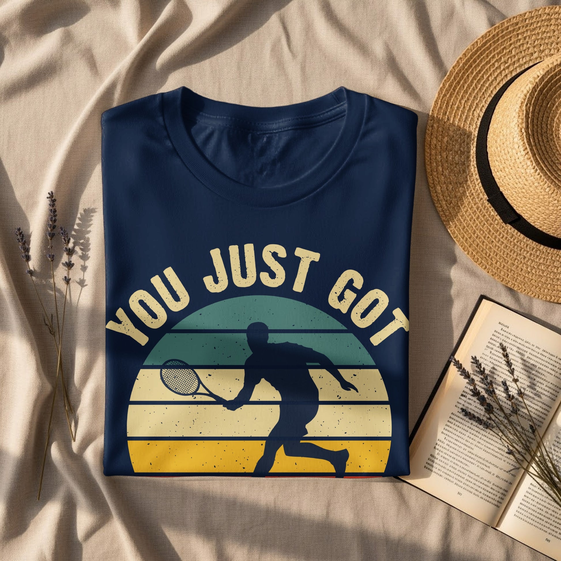 Navy t-shirt with vintage "YOU JUST GOT" tennis graphic and player silhouette.