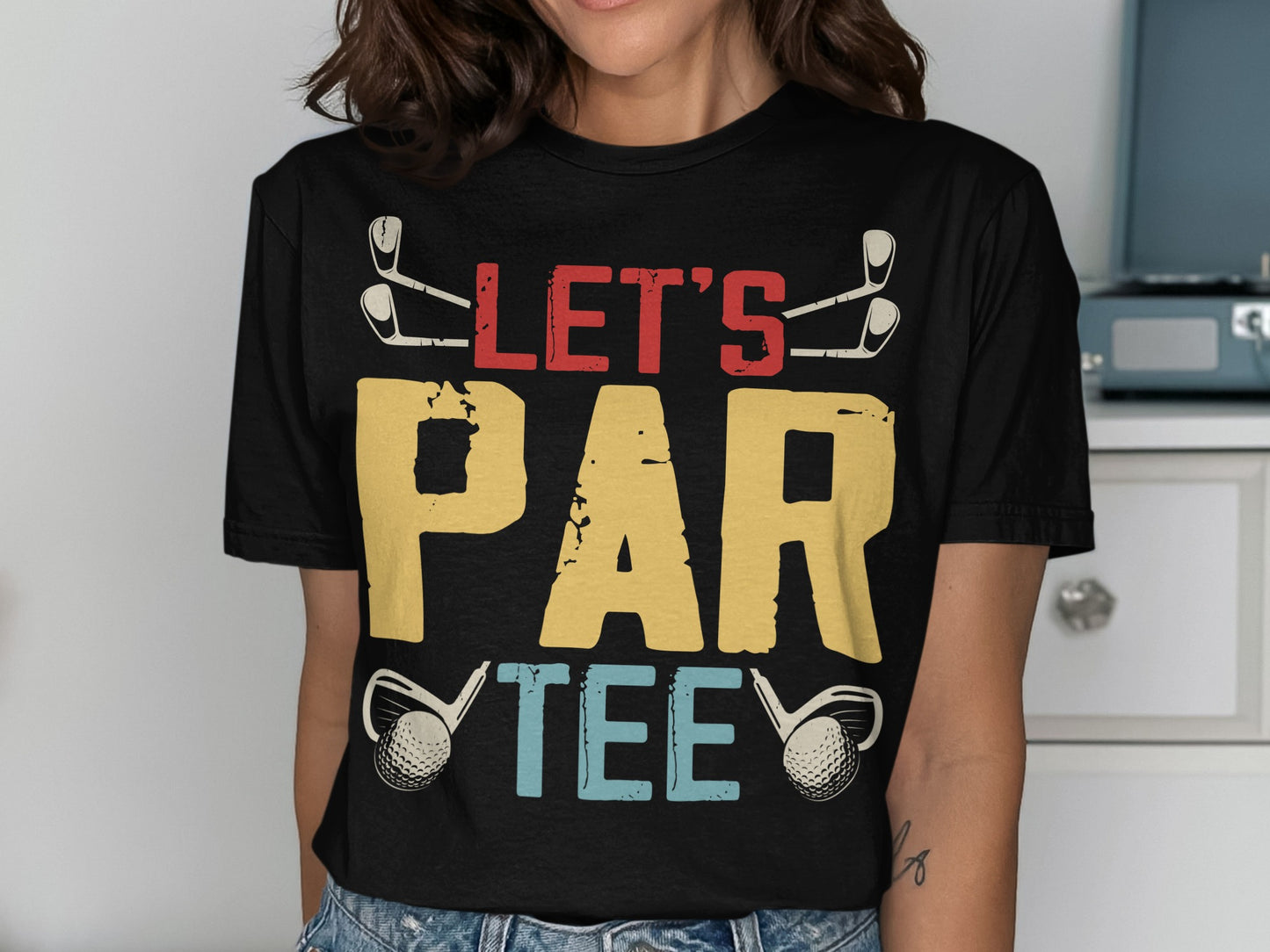 Black t-shirt with "LET'S PAR TEE" graphic, golf clubs, and golf balls.