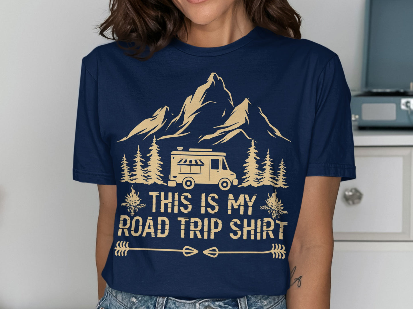 Dark blue t-shirt with mountains, camper van, trees, and "THIS IS MY ROAD TRIP SHIRT" text.