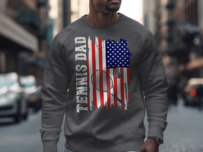 Sweatshirt with distressed US flag, tennis racket, ball, and "Tennis Dad" text.