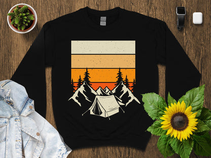 Black sweatshirt with vintage sunset mountain and tent graphic.