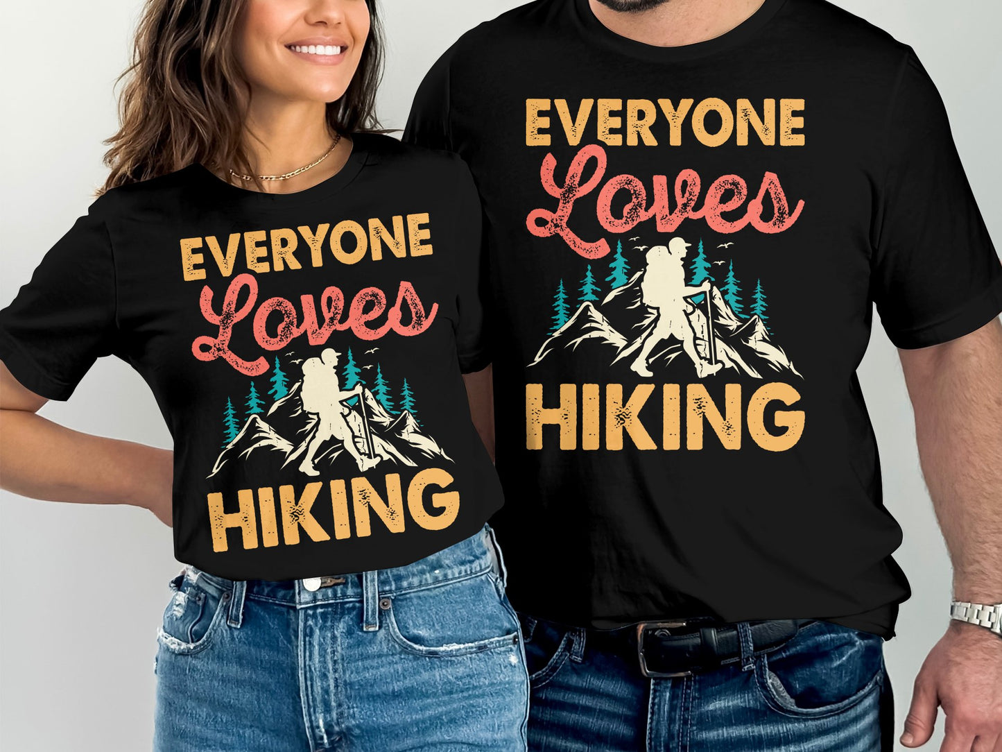 Couple wearing matching black t-shirts with "Everyone Loves Hiking" text.