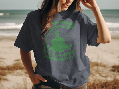 Dark t-shirt with green graphic of a fisherman and fish, "FISHMAN" text.