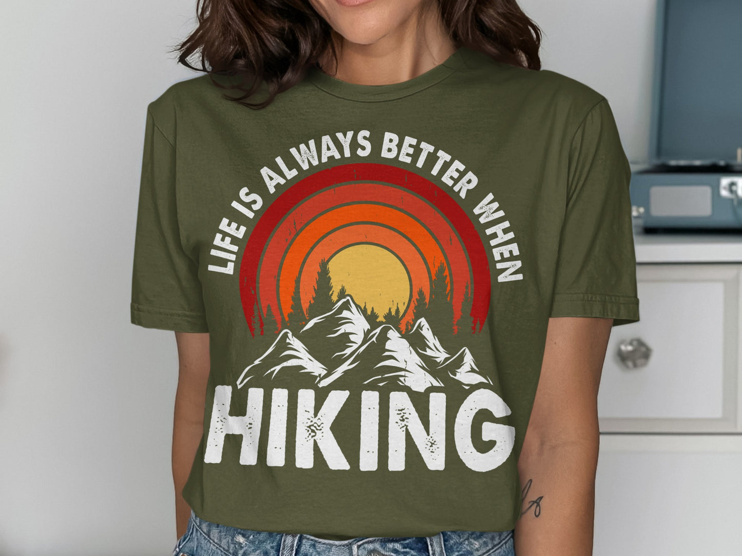 Green t-shirt with "Life is Always Better When Hiking" and mountain sunset graphic.