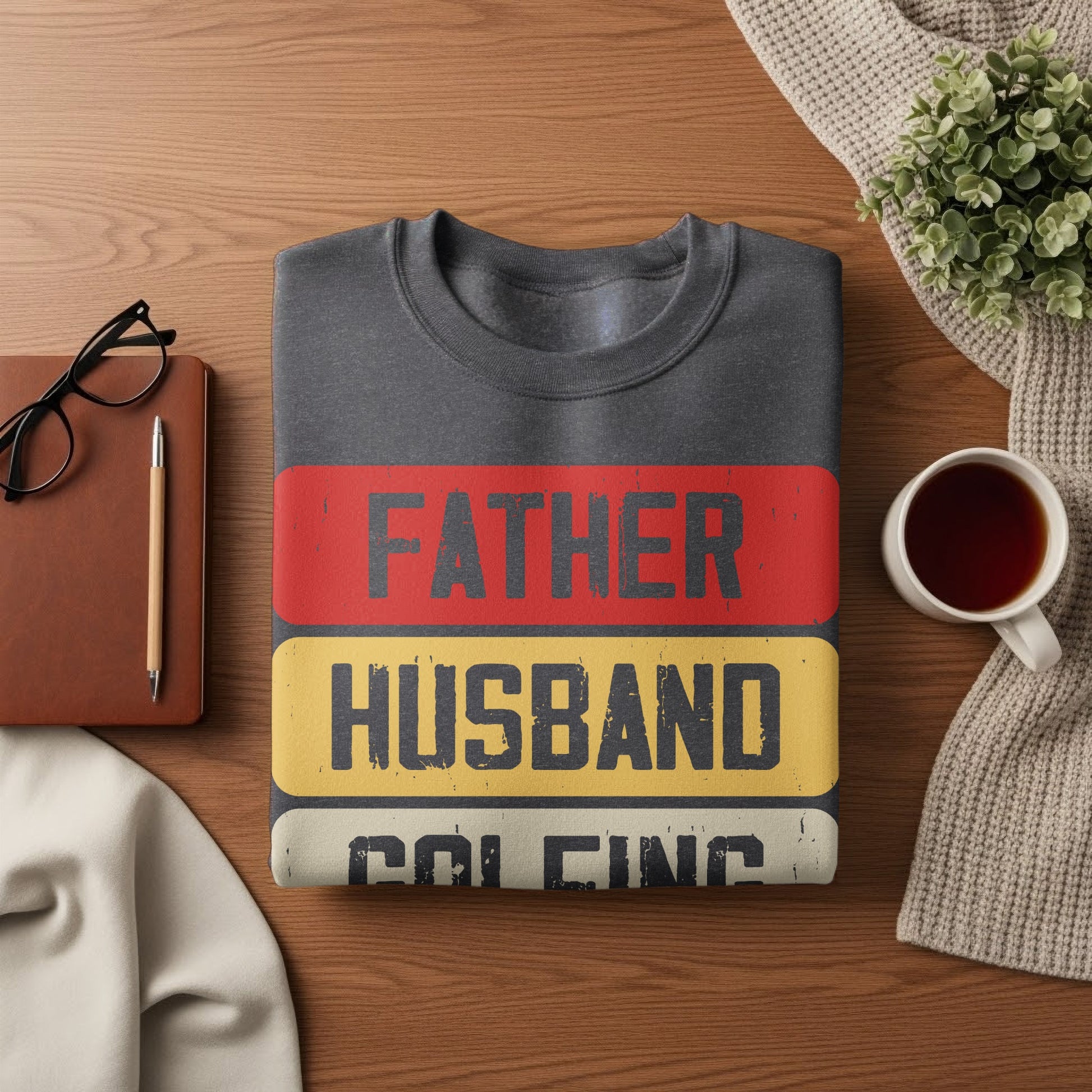 Dark gray sweatshirt with "FATHER HUSBAND" and "KING" text.