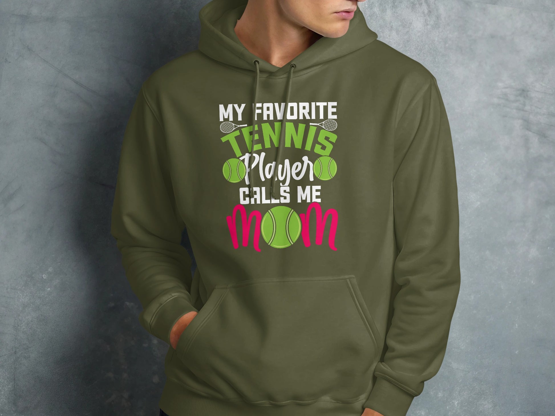 Green hoodie with text "My Favorite Tennis Player Calls Me Mom" and tennis balls.