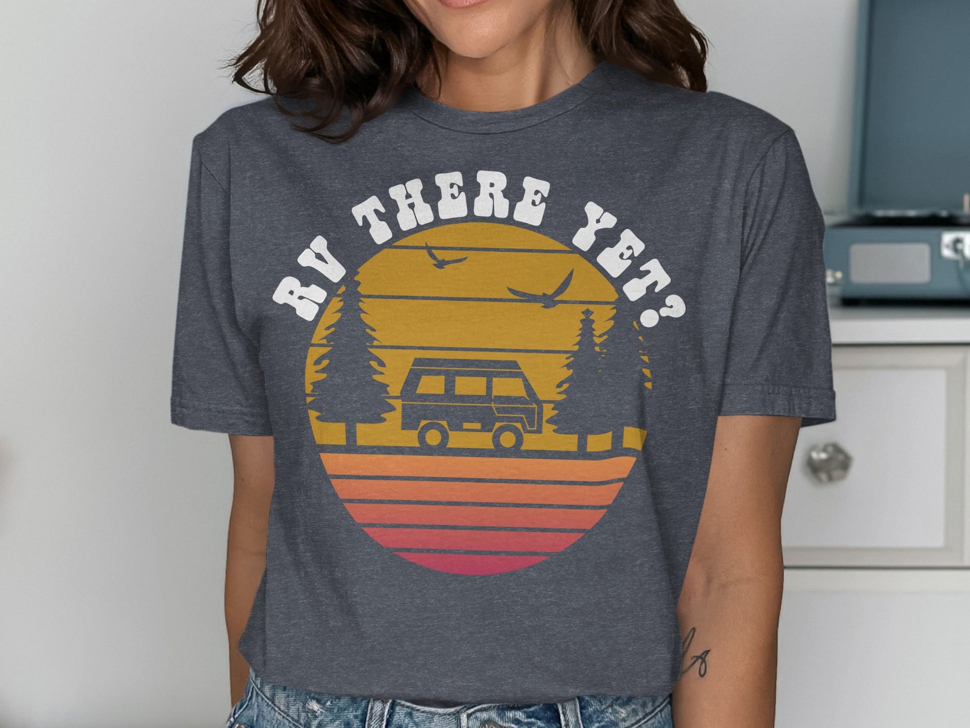 RV THERE YET? graphic on a dark gray t-shirt with retro sunset and trees.