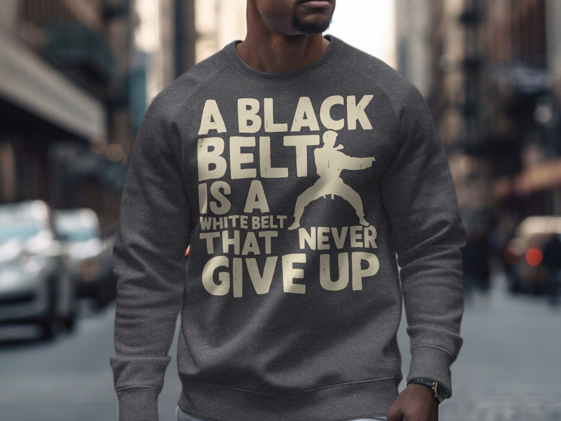 Gray sweatshirt with white text and karate graphic: "A BLACK BELT IS A WHITE BELT THAT NEVER GIVE UP."