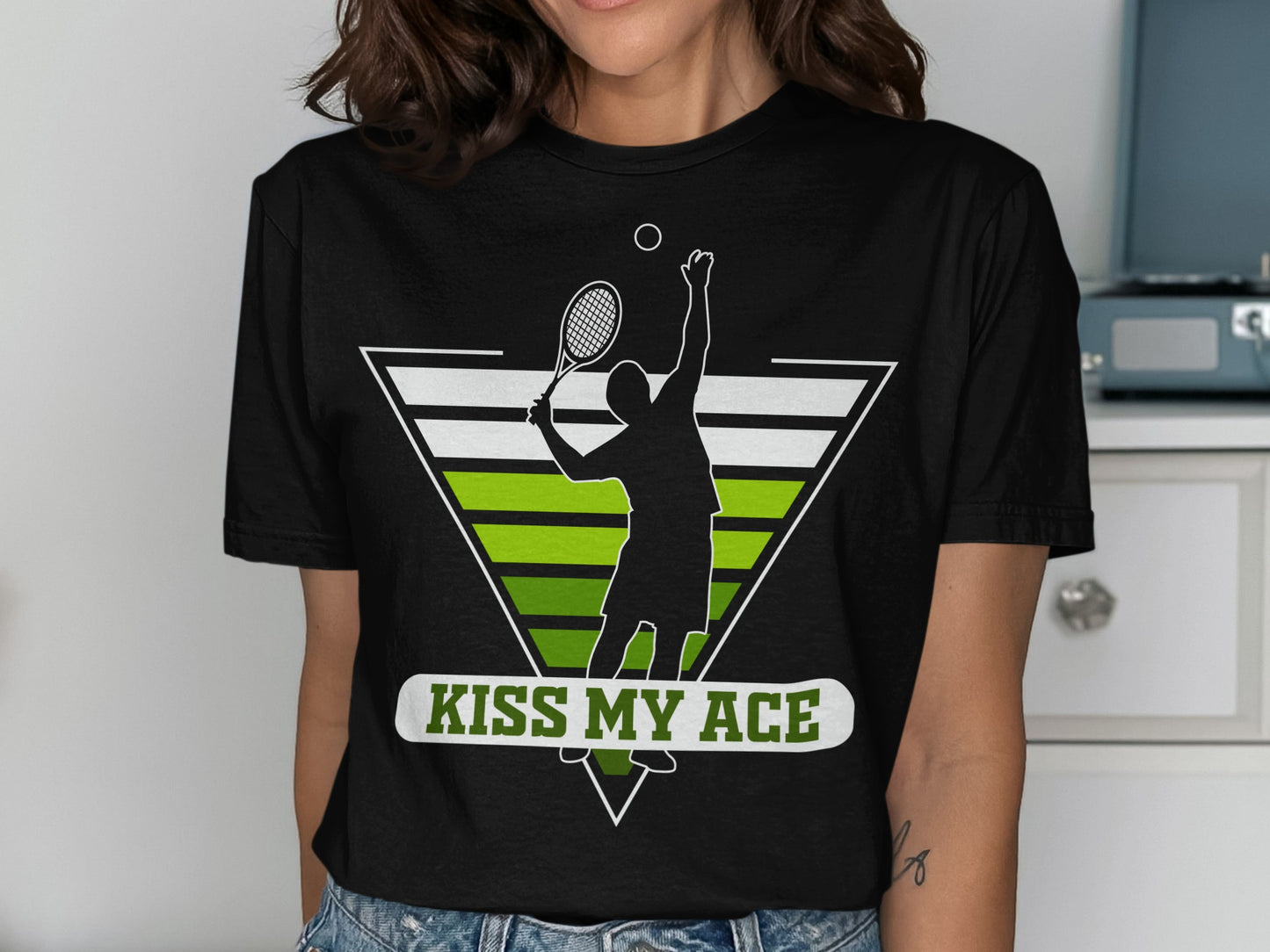 Tennis player serving a ball with "Kiss My Ace" text.