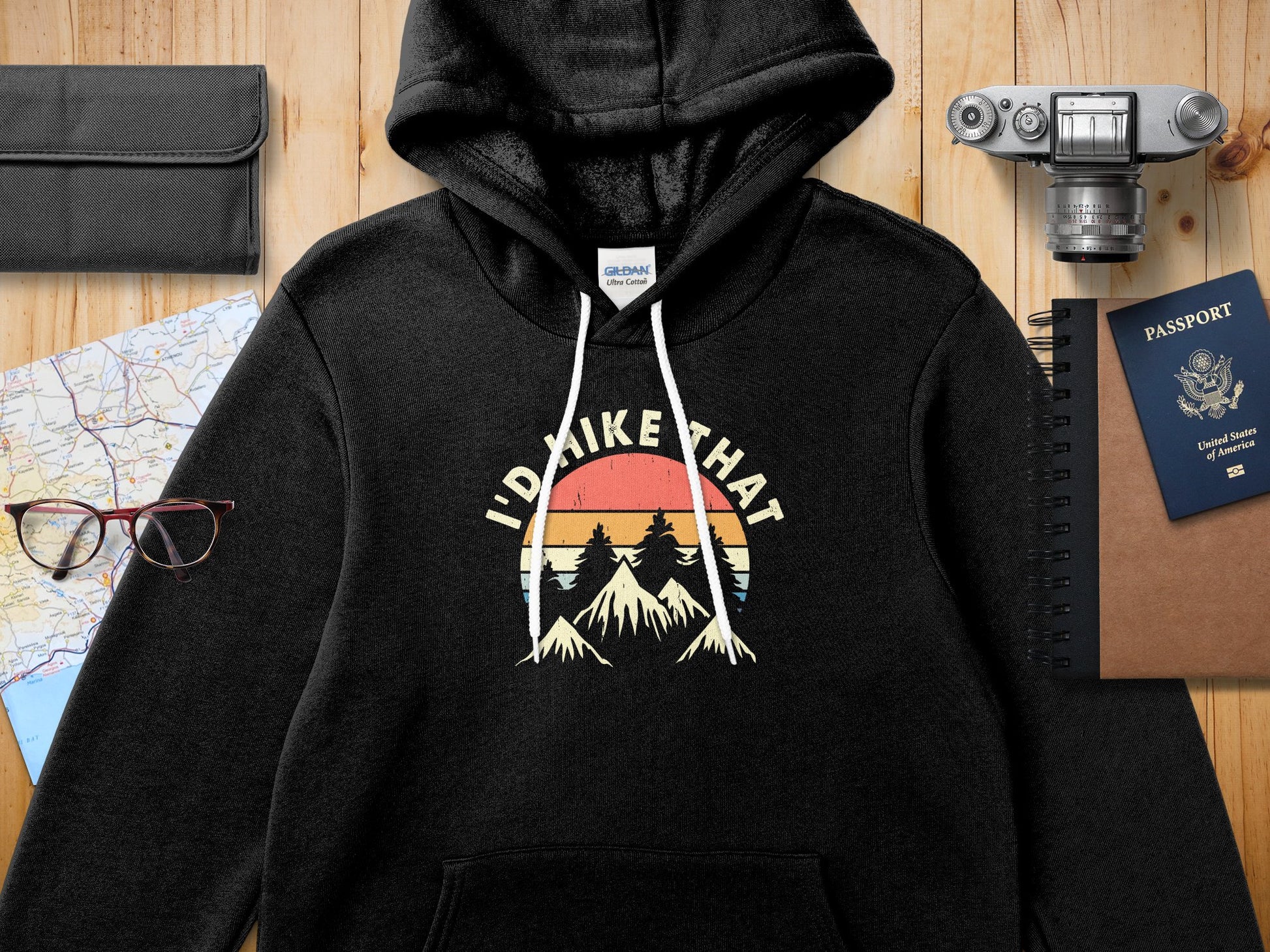 Black hoodie with "I'd hike that" mountain sunset graphic.