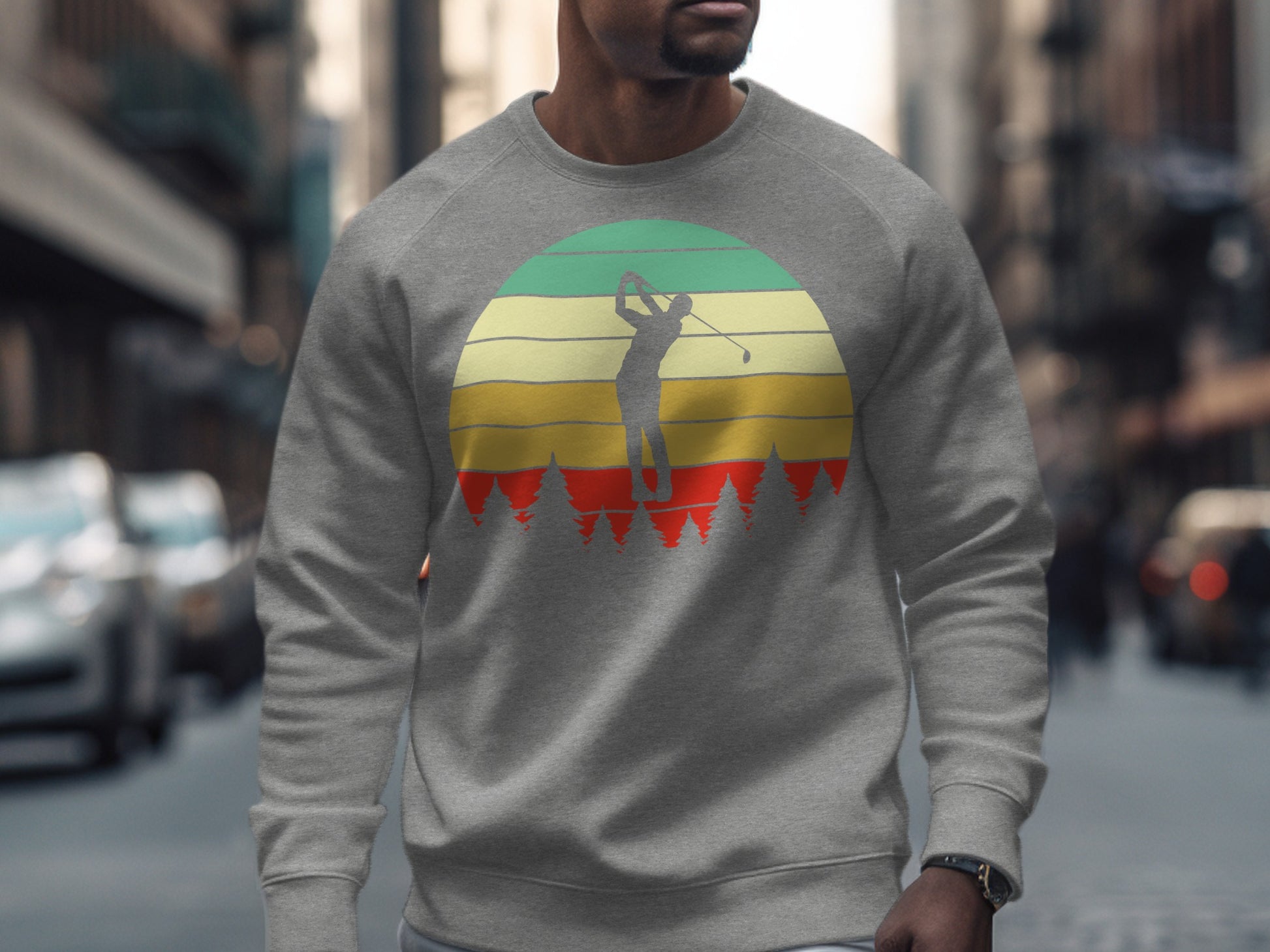 Man wearing grey sweatshirt with retro sunset golf graphic.