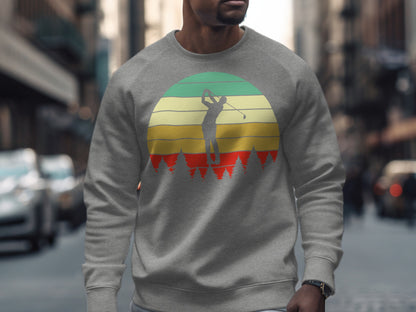 Man wearing grey sweatshirt with retro sunset golf graphic.