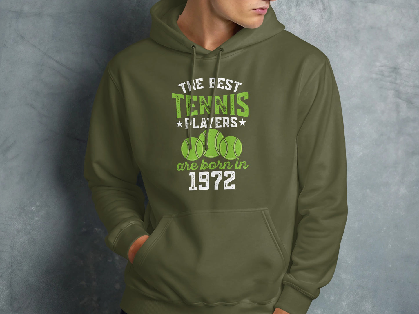 Olive green hoodie with "The Best Tennis Players Are Born In 1972" text and tennis balls.