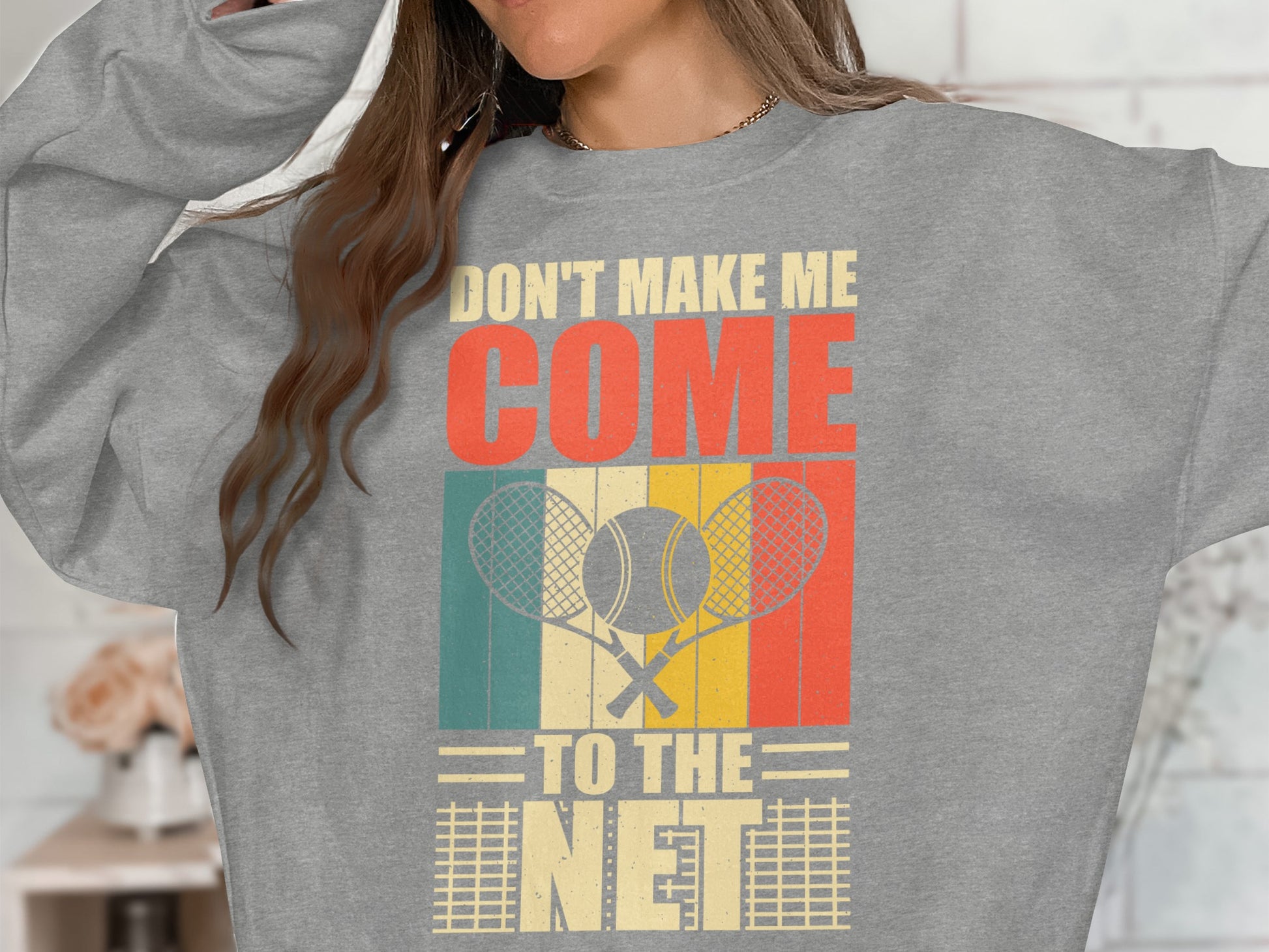 Gray sweatshirt with "Don't Make Me Come To The Net" and tennis rackets.