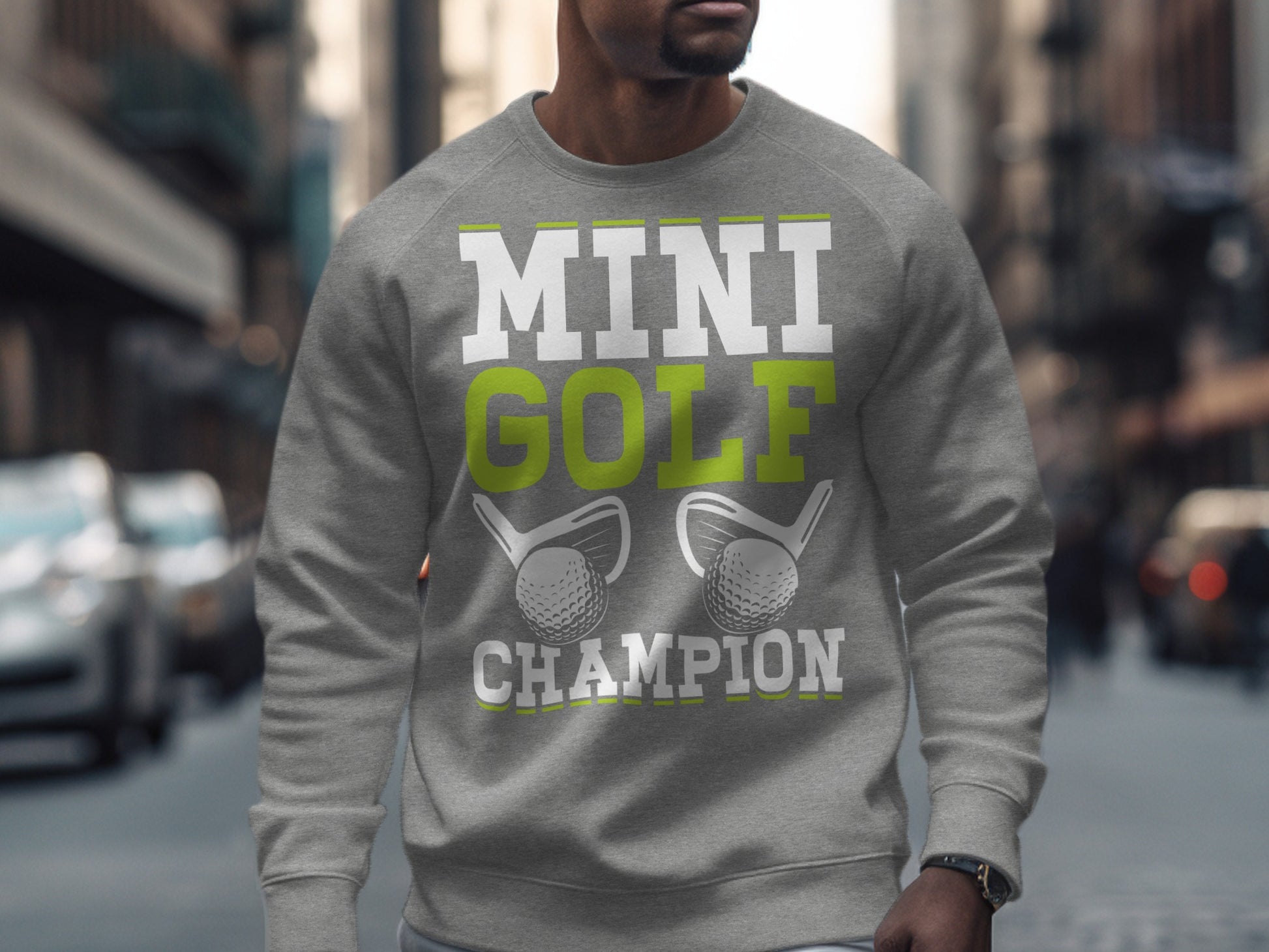 Grey sweatshirt with "MINI GOLF CHAMPION" and golf club graphic.