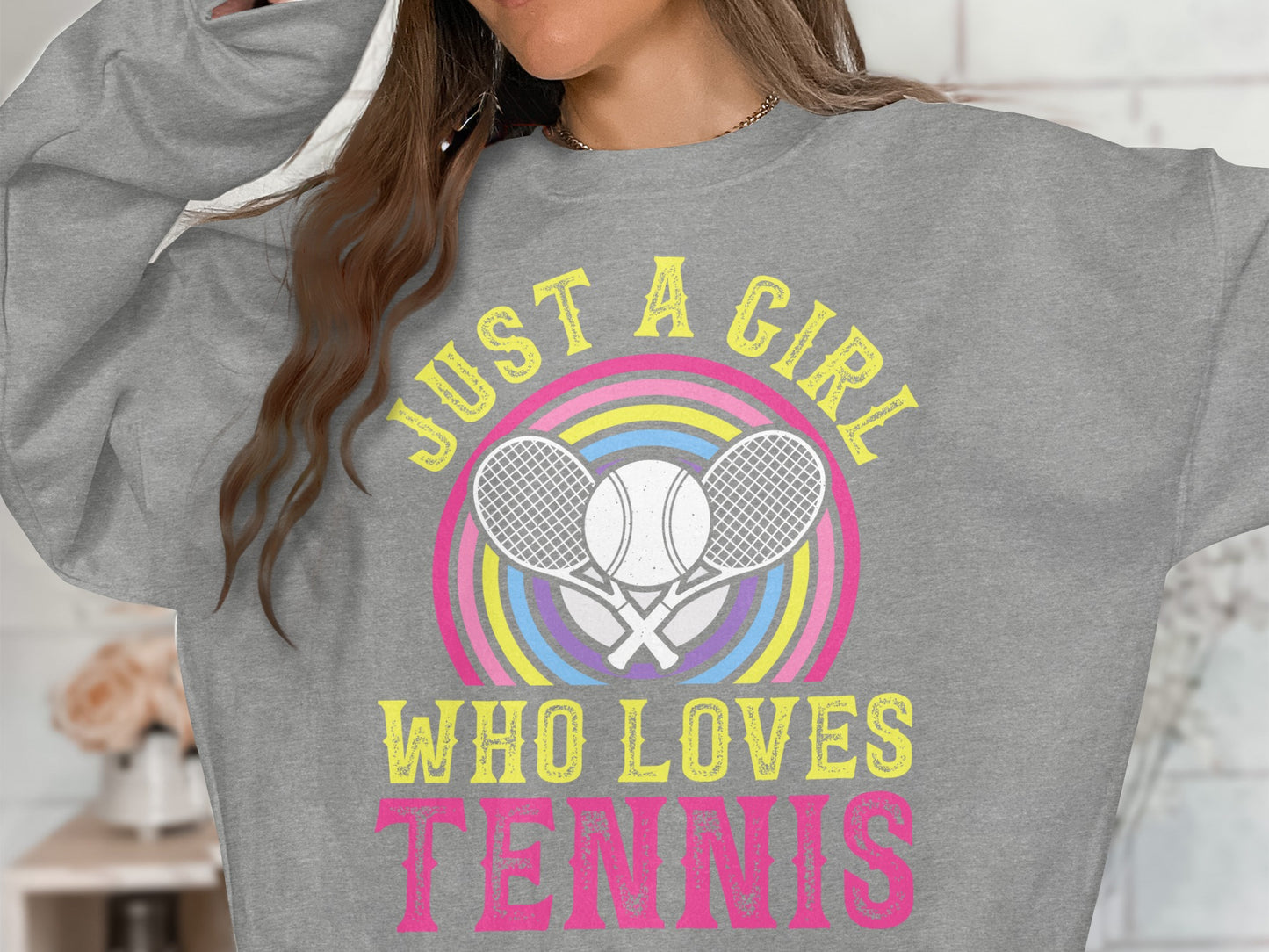 Gray sweatshirt with "Just a girl who loves tennis" and crossed rackets and rainbow.