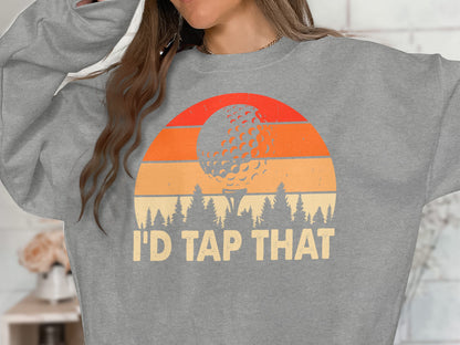 Gray sweatshirt with sunset, golf ball, trees, and "I'D TAP THAT" text.